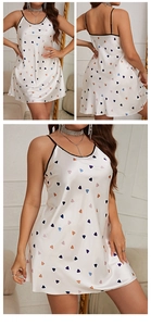 Detail of white satin nightgown featuring colorful heart prints and black strap piping