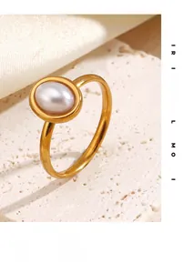 Detailed view of an oval imitation pearl set in a gold-plated stainless steel ring