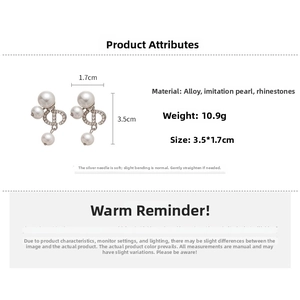 Detailed specs of pig nose earrings with pearls and rhinestones measuring 3.5x1.7cm