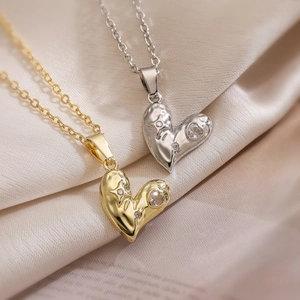 Chic gold and silver lava heart necklaces with sparkling zircons on silk fabric