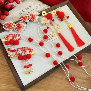 Detailed shot of traditional Chinese koi fish hair clips with festive red tassels and pearls