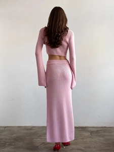 Back view of a pink ribbed knit two-piece set featuring long sleeves and a slim maxi skirt