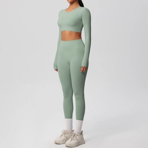 Side view of model wearing sage green long sleeve crop top and high waist yoga leggings set