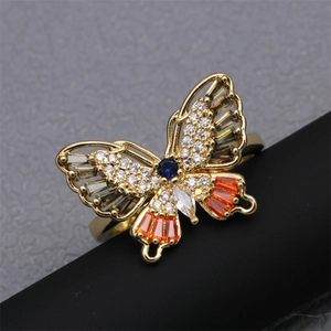 Macro view of gold butterfly ring featuring multi-color zircons and intricate hollow design