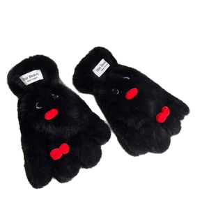 Cartoon penguin plush gloves in black faux fur with red bow accents and wrist labels