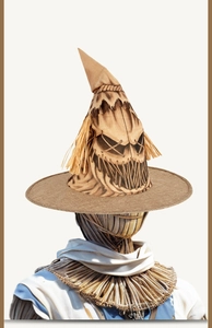 Macro shot of rustic burlap scarecrow witch hat with stitched scary face and straw detail