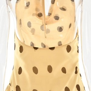 Detailed macro view of beige polka dot fabric and smooth texture of the summer mini dress