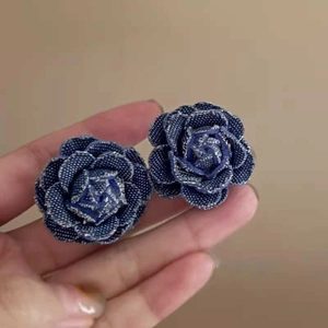 Vue détaillée des boucles d'oreilles rose en denim fait main avec pendentif perle