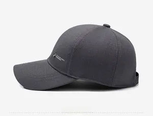 Detail view of dark grey baseball cap featuring side logo embroidery and shield emblem