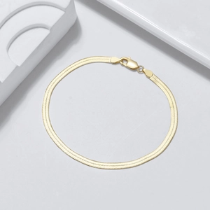 Close-up of S925 sterling silver gold-plated flat snake chain bracelet with lobster clasp