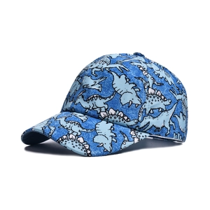 Detail of adjustable blue kids' baseball cap with light blue dinosaur print pattern