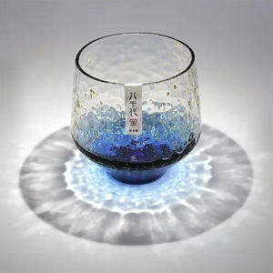 Detail of Japanese hammer pattern wine glass with blue gradient finish and gold foil accents