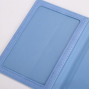 Close-up of light blue leather passport holder with a transparent PVC card slot