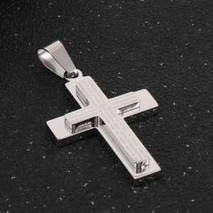 Macro view of silver stainless steel double-layered cross pendant with Lord's Prayer engraving