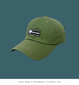 Close-up of olive green baseball cap with hand made patch and reinforced brim stitching