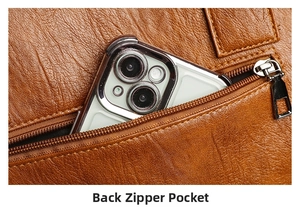 Detailed view of the back zipper pocket on a brown lychee leather tote bag with a smartphone