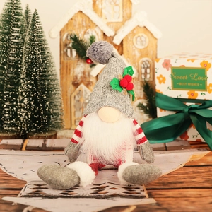Detail of Nordic Christmas gnome with grey knitted hat, white beard, and red berry accents