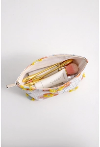 Close-up of floral embroidered canvas makeup bag with soft tassels and large capacity