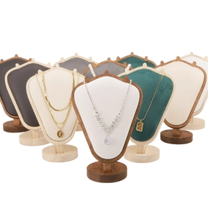 Detail view of velvet jewelry busts in various colors with sturdy wooden bases