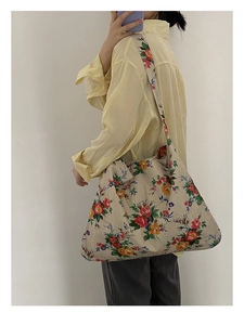 Detailed close-up of a large capacity floral tote bag with vintage flower print and wide strap