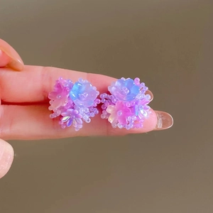 Close-up of floral bead earrings with pink and purple gradient resin petals