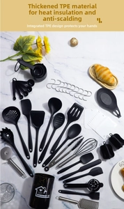 Macro view of 20-piece black silicone kitchen utensil set with marble storage canister