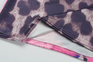 Macro shot of purple leopard print fabric showing high-quality stitching and seam details