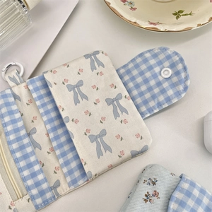 Detailed interior of floral fabric wallet showing snap button, card slots, and zip pocket