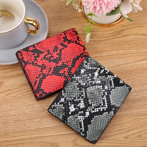 Men's vintage bifold wallets with snakeskin texture in red and grey on wooden desk