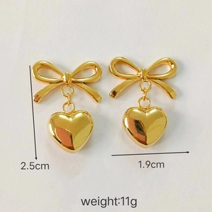 Detailed view of 18K gold stainless steel bow heart earrings with 2.5cm height dimension