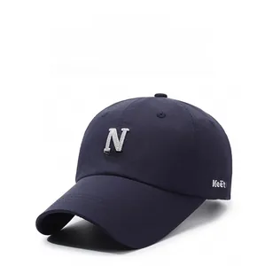 Macro detail of navy cotton baseball cap showing white N Eastern embroidery and stitching