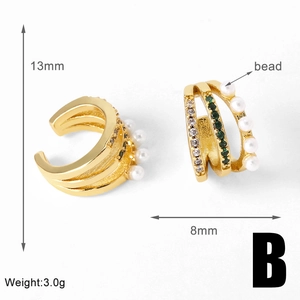 Macro detail of 18k gold plated pearl ear cuff with green zircon inlay, 13mm size