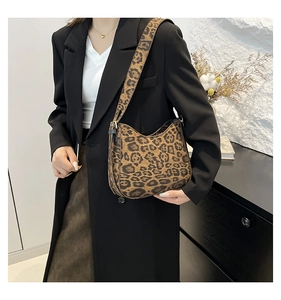 Detail of trendy leopard print shoulder bag featuring premium texture and matching strap