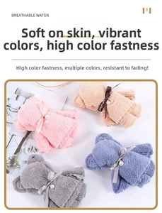 Detailed view of bear-shaped coral fleece towels in four colors with pearl bow ribbons