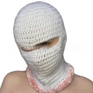 Detail of handmade crochet balaclava with white mesh texture and pink fluffy faux fur trim