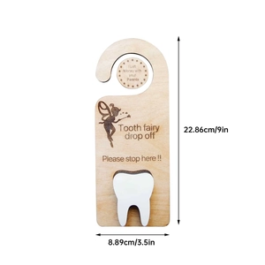 Wooden tooth fairy door hanger with a white tooth-shaped pouch and laser-engraved fairy design
