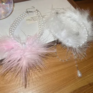 Double-layer pearl necklace with feather tassels and elegant beaded choker design