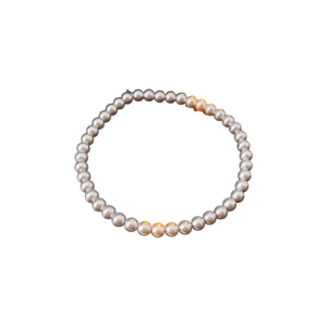 Elegant vintage rose-toned pearl beaded bracelet in a circular minimalist display