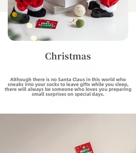 Close-up of Santa Claus plush with Merry Christmas card and festive LED string lights