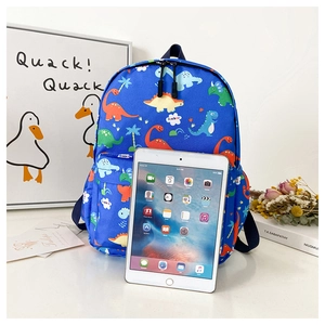 Size comparison of blue cartoon dinosaur backpack next to an iPad for 3-7 year olds