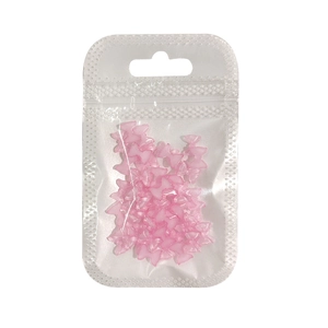 Bulk pack of 50 pink resin bowknot nail art charms in a transparent sealing bag