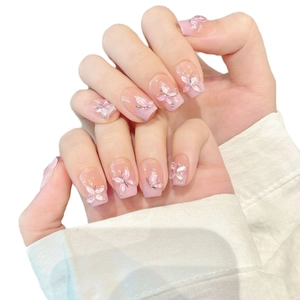 Handmade pink gradient press-on nails with 3D butterfly accents and glitter