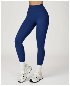 Close-up of high-waisted navy blue yoga leggings with elastic quick-dry compression fabric