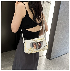 Detailed view of the white and yellow PU ita bag with a clear PVC window for pin badges