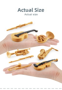 Miniature musical instrument models set held in palm to show accurate actual size