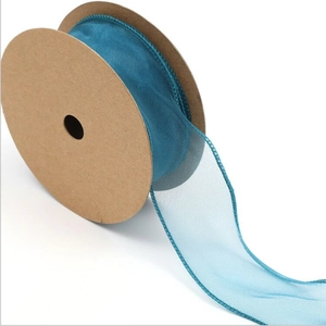 Detail of blue sheer fishtail chiffon ribbon on brown kraft roll for gift wrapping