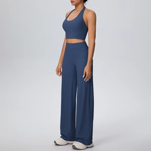 Detail of dark blue halter-neck sports bra and high-waist wide-leg yoga pants set