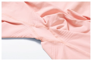 Macro shot of pink yoga pants with seamless rib texture and reinforced stitching