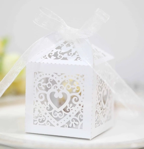 Detailed laser-cut heart hollow design on white wedding favor box with ribbon