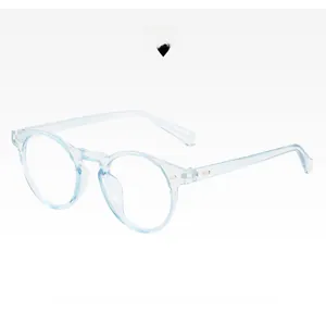 Detail of round light blue glasses frame with metal rivets on minimalist white background